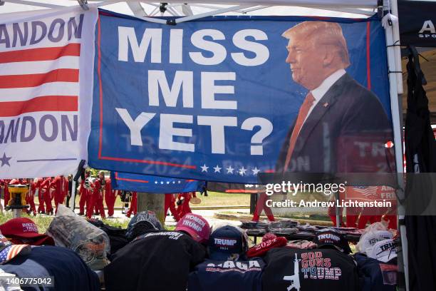 Donald Trump supporte stand sells Trump merchandise as the Travis July 4th parade marches through the Travis neighborhood on July 4, 2022 in Staten...