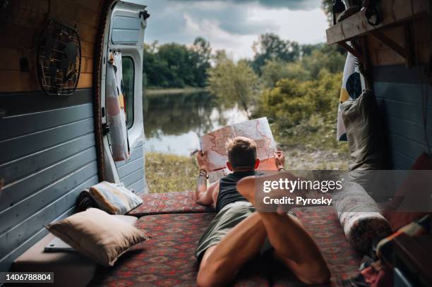 checking the map to see their next location - van life stock pictures, royalty-free photos & images