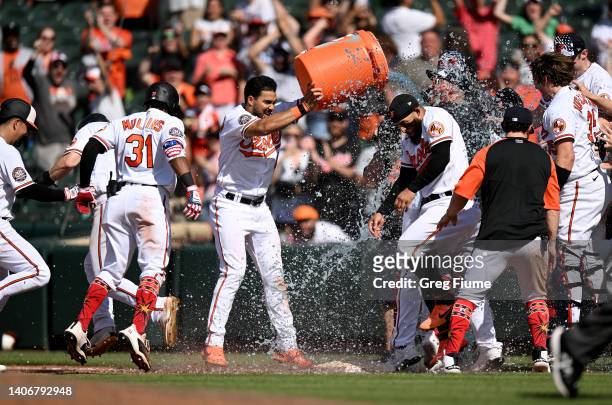 Jorge Mateo of the Baltimore Orioles celebrates with teammates after driving in the game winning run by getting hit with a pitch in the tenth inning...