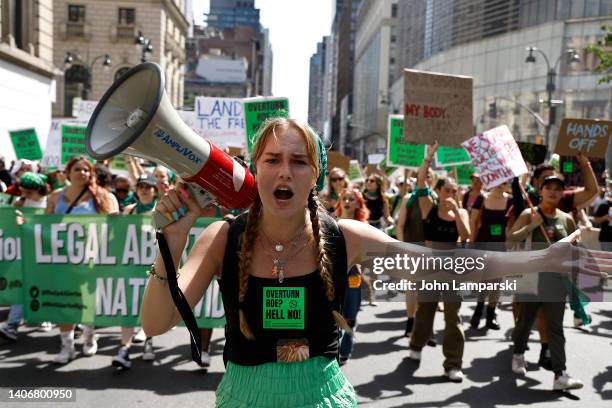 Demonstrator chants slogans as she marches through the streets to demonstrate against the Supreme Court on July 4, 2022 in New York City. The Supreme...
