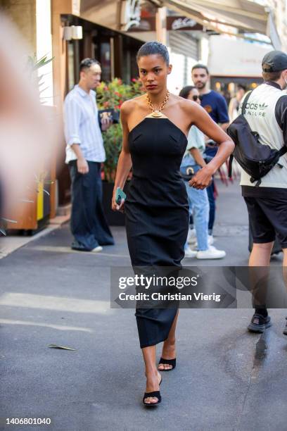 Tina Kunakey is seen wearing black dress outside Schiaparelli during Paris Fashion Week - Haute Couture Fall Winter 2022 2023 : Day One on July 04,...
