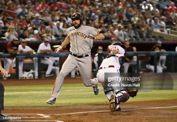 Darin Ruf of the San Francisco Giants scores ahead of the throw to Carson Kelly of the Arizona Diamondbacks on a two-run single off the bat of...