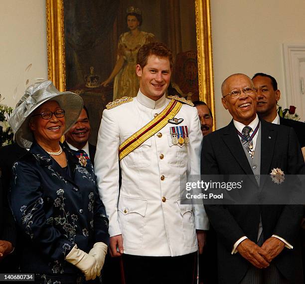 Britain's Prince Harry poses with Bahamas former Governor General Ivy Dumont and Governor General Arthur Foulkes during a reception at Government...