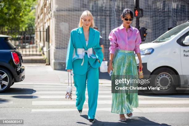 Justyna Czerniak seen wearing corset, turquoise oversized suit, Paco Rabanne bag & Pornwika Spiecker wearing pink button up skirt, green glitter high...