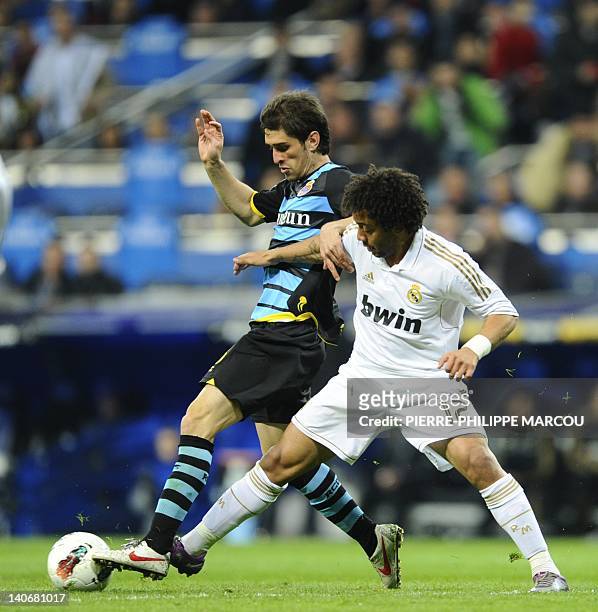 Real Madrid's Brazilian defender Marcelo fights for the ball with Espanyol's Argentinian defender Juan Forlin on March 4, 2012 during a Spanish...