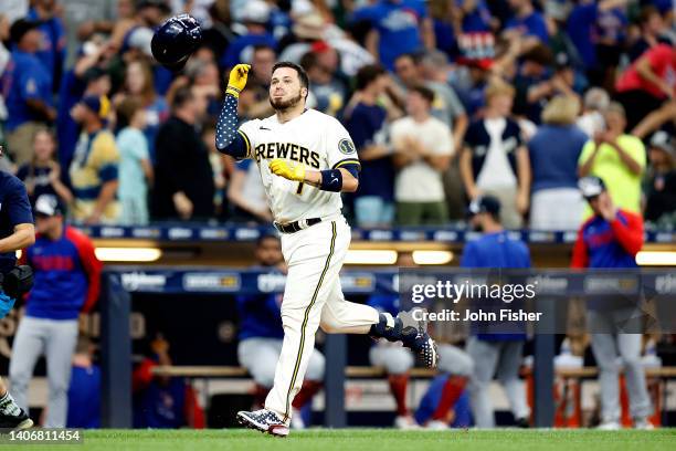 Victor Caratini of the Milwaukee Brewers flips his helmet before crossing home plate on his walk-off, three-run home run in the 10th inning against...