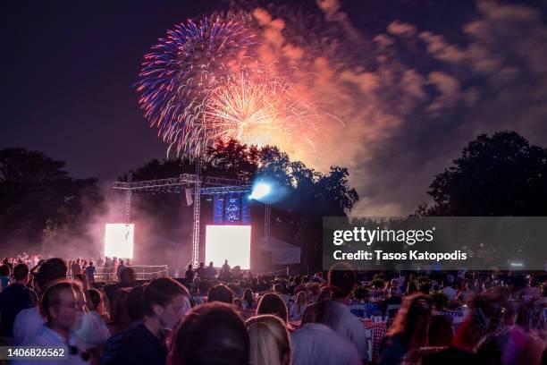 Guests on the south lawn watch the fireworks go off on national mall from the White House on July 04, 2022 in Washington, DC. U.S. President Biden...