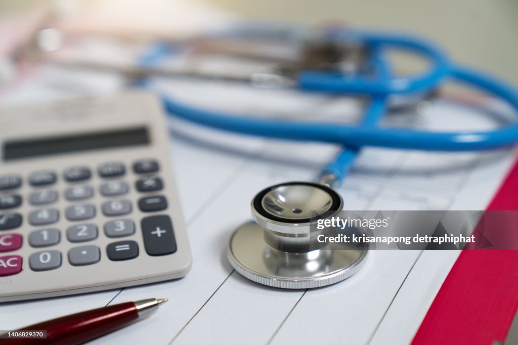 Cost of health care concept, stethoscope and calculator on document