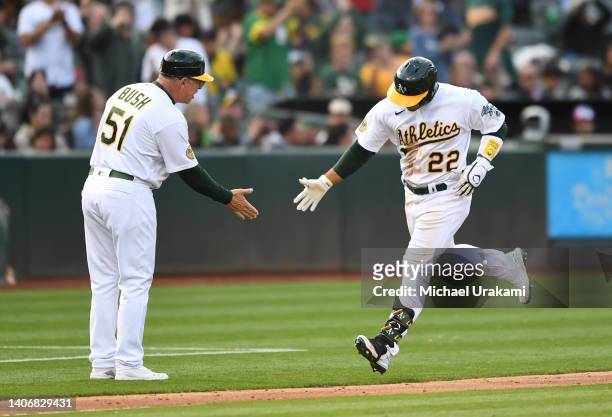 Ramon Laureano of the Oakland Athletics high fives third base coach after hitting a homerun in bottom of the fifth inning against Alek Manoah of the...