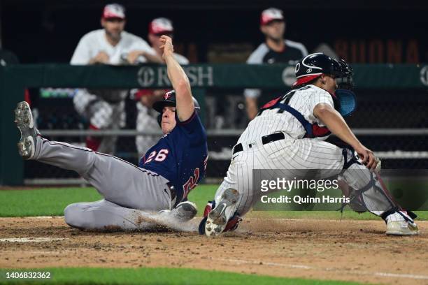 Max Kepler of the Minnesota Twins slides at home plate to score in the 10th inning against Seby Zavala of the Chicago White Sox at Guaranteed Rate...