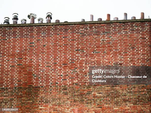 weathered brick wall with chimneys in paris, france. - high section bildbanksfoton och bilder