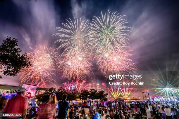 Spectators gather at Gantry Plaza State Park in Queens to watch to 2022 Macy's fireworks display on July 04, 2022 in New York City.