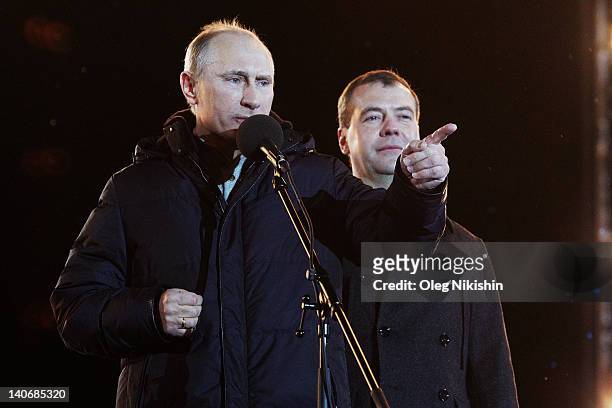 Russian Prime Minister and presidential candidate Vladimir Putin speaks as current President Dmitry Medvedev listens during a rally after Putin...