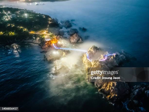 summer sea fog flows over daewangam rock - surrounding imagens e fotografias de stock