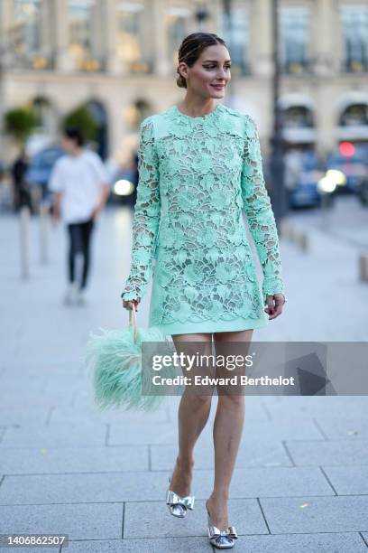 Olivia Palermo wears a pale green / mint green lace print pattern long sleeves short dress, a matching mint green fluffy / feathers handbag, silver...