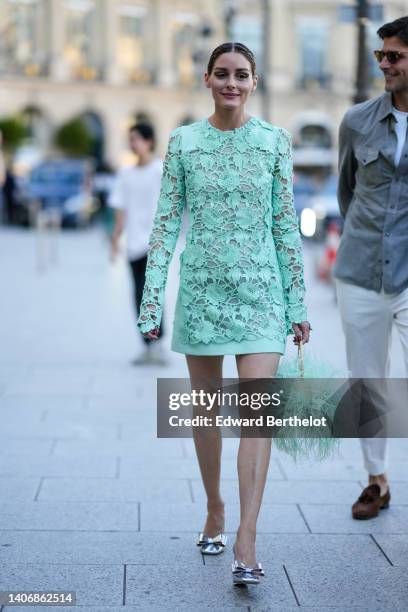 Olivia Palermo wears a pale green / mint green lace print pattern long sleeves short dress, a matching mint green fluffy / feathers handbag, silver...