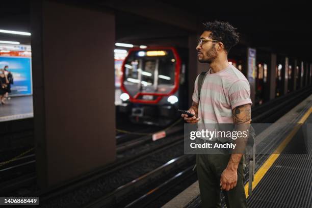 man waiting for subway at station - railroad station platform stock pictures, royalty-free photos & images