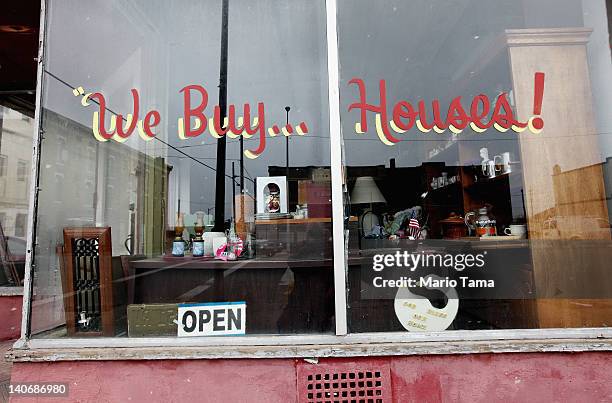 Thrift shop with a sign reading "We Buy Houses!" is seen on March 4, 2012 in Lima, Ohio. A census report released in 2011 showed that 15.3 percent of...