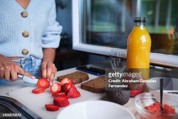 side view unrecognizable person slicing organic strawberries with a knife in the kitchen for brunch - chop stock pictures, royalty-free photos & images