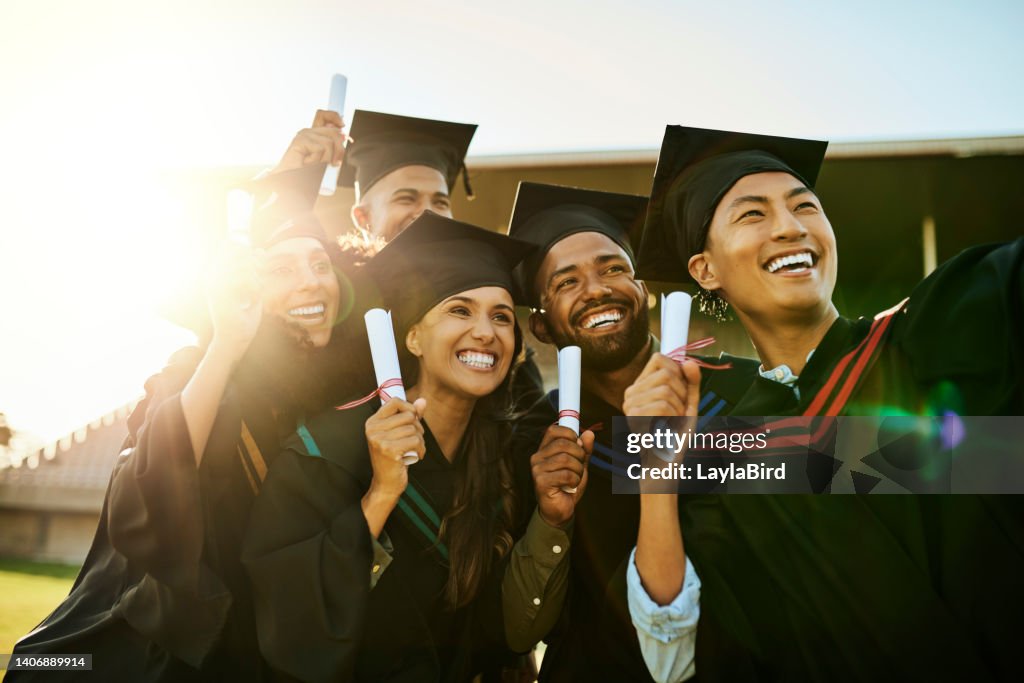 Alunos qualificados no dia da formatura. Grupo de alunos em vestidos tirando uma selfie com telefone na cerimônia. Graduados motivados capturando fotos memoráveis, celebrando realização acadêmica e marco