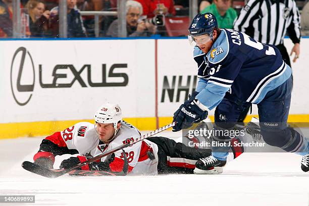 Brian Campbell of the Florida Panthers tangles with Zenon Konopka of the Ottawa Senators at the BankAtlantic Center on March 4, 2012 in Sunrise,...