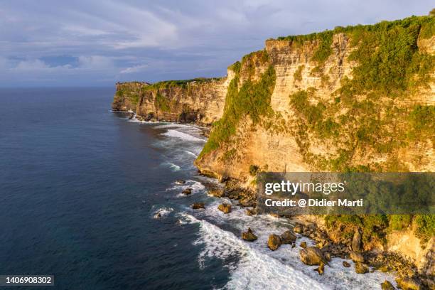 aerial view of the cliff at uluwatu, bali in indonesia - uluwatu stock pictures, royalty-free photos & images