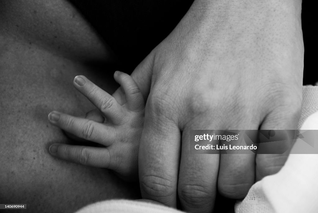 Mom hand holding child hand