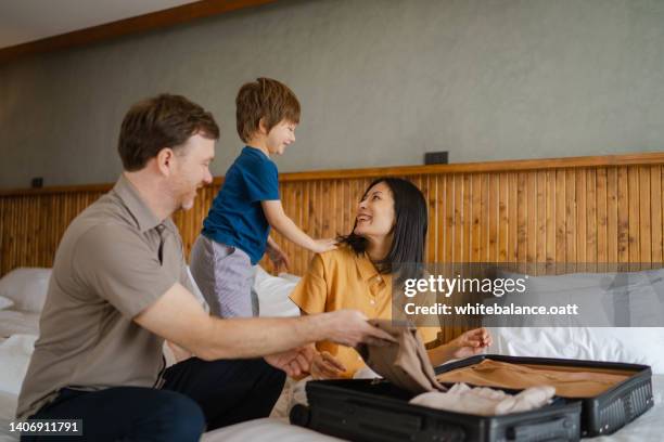 happy family prepare luggage for the holidays. - happy holidays family stock pictures, royalty-free photos & images