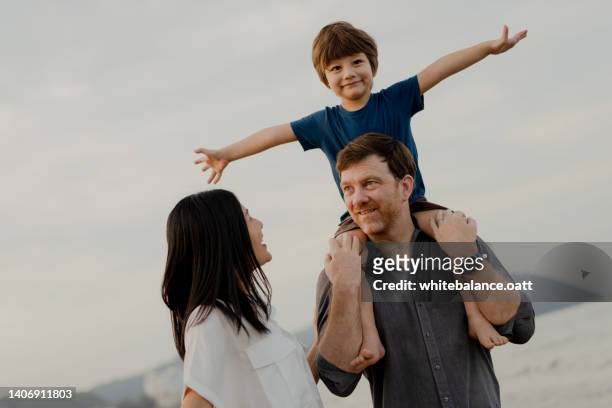happy family having fun at the beach on vacation. - tourist mother father child thailand stock pictures, royalty-free photos & images