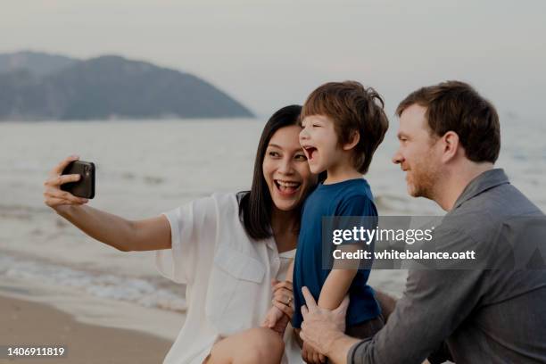 happy family having fun at the beach on vacation. - tourist mother father child thailand stock pictures, royalty-free photos & images