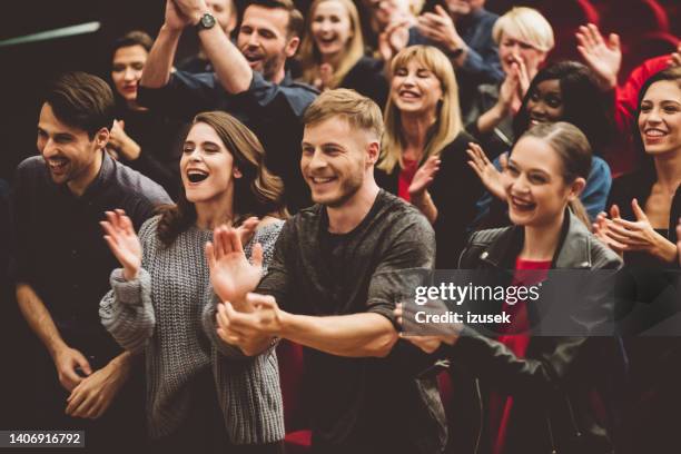 happy audience applauding in the theater - komiek stockfoto's en -beelden