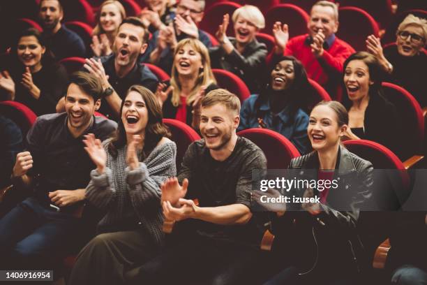 happy audience applauding in the theater - theatrical performance stock pictures, royalty-free photos & images