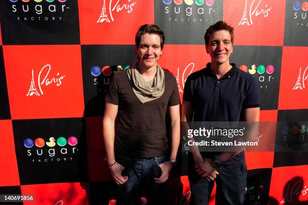 Actors James Phelps and Oliver Phelps arrive for an autograph signing at the Sugar Factory American Brasserie at the Paris Las Vegas on March 4, 2012...