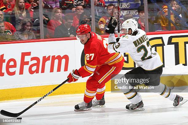 Derek Smith of the Calgary Flames skates against Tom Wandell of the Dallas Stars on March 4, 2012 at the Scotiabank Saddledome in Calgary, Alberta,...