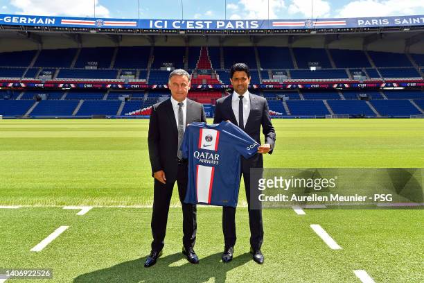 Newly appointed Paris Saint-Germain coach Christophe Galtier and PSG President Nasser Al Khelaifi pose with the jersey at Parc des Princes on July...