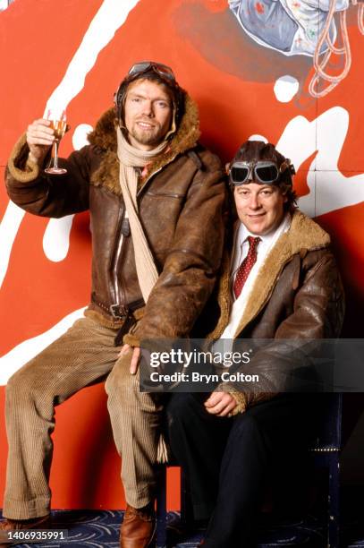 Richard Branson, co-founder of Virgin Atlantic Airways, in a leather flying jacket and helmet with his fellow co-founder of Virgin Atlantic Airways...