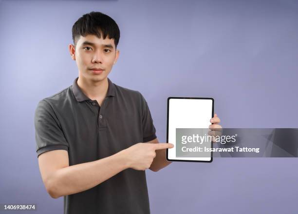 portrait of nice attractive cheerful content guy in formal shirt holding in hands showing digital tablet new product isolated on bright vivid shine vibrant purple color background - formal shirt stock pictures, royalty-free photos & images