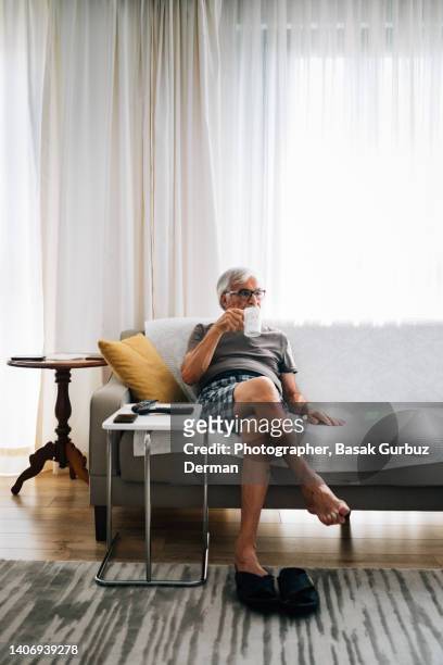 old man watching tv, drinking tea - english tea room stock pictures, royalty-free photos & images