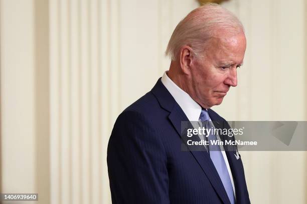 President Joe Biden bows his head in prayer before presenting the Medal of Honor to four U.S. Army soldiers who fought in the Vietnam War during an...