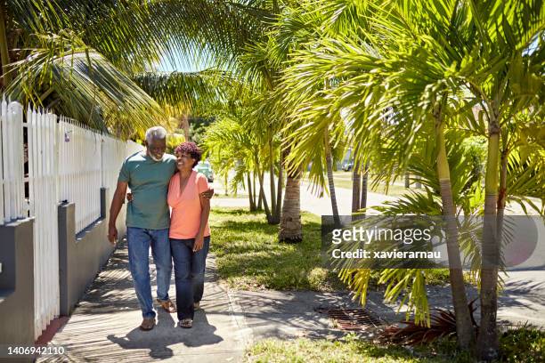 miami seniors walking together in residential district - casual southern stock pictures, royalty-free photos & images