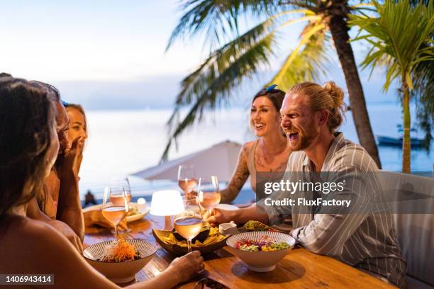 multiracial female and male friends having dinner at the modern restaurant - restaurant outside stock pictures, royalty-free photos & images
