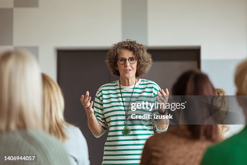 Woman sharing experience during seminar Woman sharing experience during seminar
