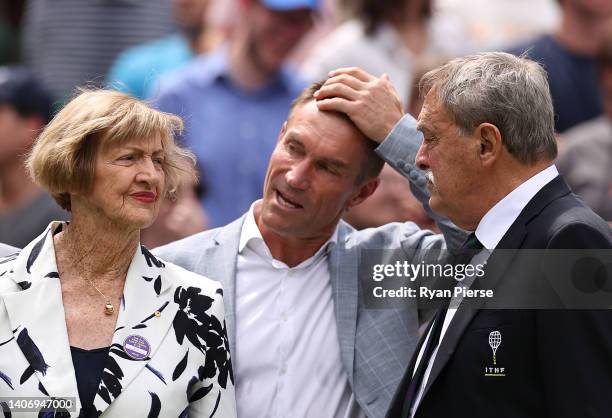 Former Wimbledon Champions, Margaret Court, Pat Cash and John Newcombe look on during the Centre Court Centenary Ceremony during day seven of The...