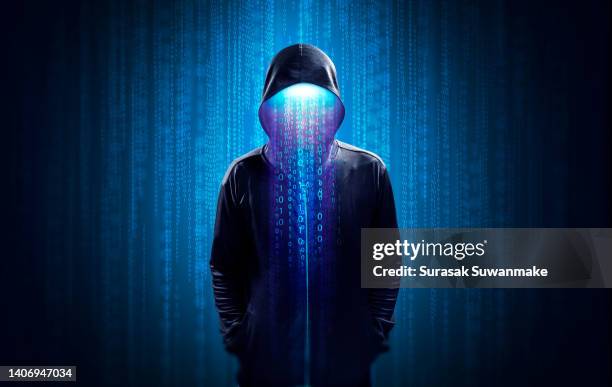 faceless hackers and malware hackers use laptops with dangerous digital code on binary code background. - robo de identidad fotografías e imágenes de stock