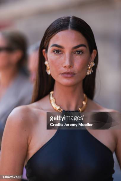 Lily Aldridge seen wearing gold earrings and a black dress with golden detail, outside the Schiaparelli show, during Paris Fashion Week - Haute...