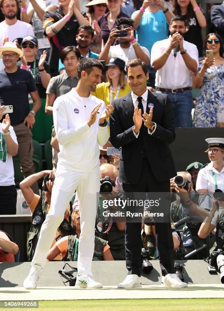 Novak Djokovic of Serbia and Roger Federer of Switzerland look on during the Centre Court Centenary Celebration during day seven of The Championships...