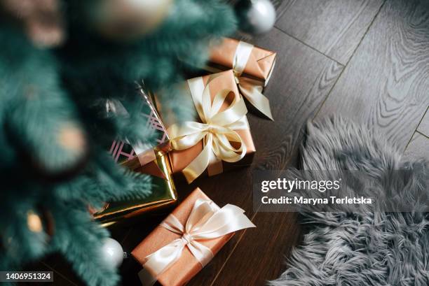 gifts under the christmas tree on the floor. gift wrapping. surprise. new year. christmas. - christmas presents under tree stock pictures, royalty-free photos & images