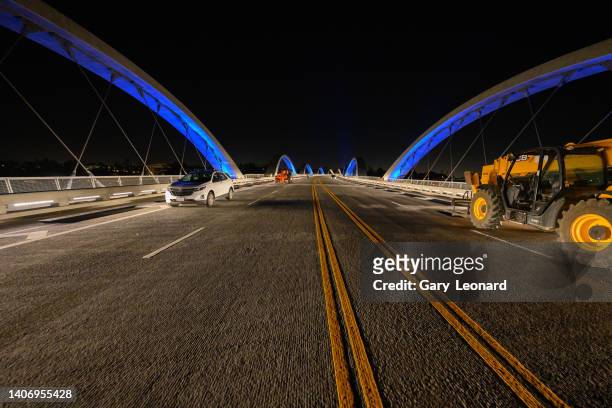 Low angle night view of the bridge with its fresh double yellow lines as an LED lighting test illuminates the arches blue during the construction of...