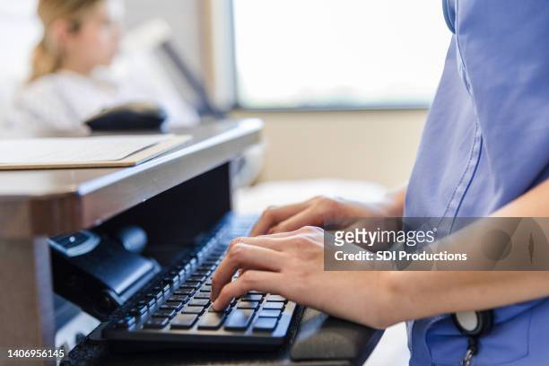 focus on healthcare worker's hands typing on computer keyboard - electronic medical record stock pictures, royalty-free photos & images