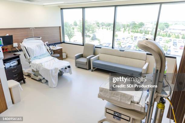 empty room in obstetrics unit with bed and infant warmer - birthing chair stock pictures, royalty-free photos & images